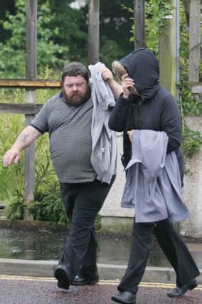 Kevin Kinney, and his wife Sharon (hooded) arrive at Coleraine Court.PICTUE MARK JAMIESON.