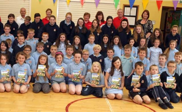 BIBLES. Members of Stranocum Community Association, who presented sixty Bibles to pupils at Bushvalley PS on Friday. Included are Principal Pala Whyte and Samantha Williams.INBM25-15 088SC.