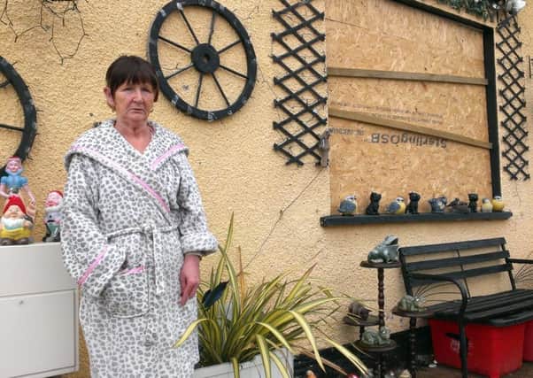 Rathcoole pensioner Isobel Nixon pictured outside her Nendrum Gardens home, which has been boarded up after the house was attacked last week. INNT 31-511CON