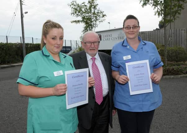 Mr Des Wilson, director of Larne Care Centre presents 5 year service Awards to Care Asst. emma Duffin and Staff Nurse, Joanne Sloan. INLT 26-200-AM