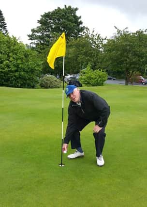 Frank Wallace picks his ball out of the cup after his hole-in-one at Banbridge!
