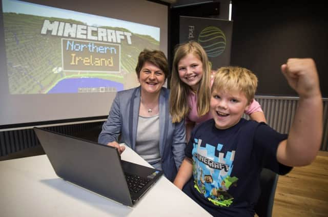 Finance Minister Arlene Foster launching the new Minecraft Northern Ireland map with Stephanie Briggs, 11 and Nathan Hardy, 9.