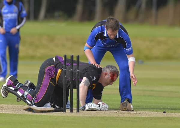 Neil Russell of Instonians is floored after taking a ball on the head from CIYMS' Johnny Thompson. Pictured by Rowland White/PressEye