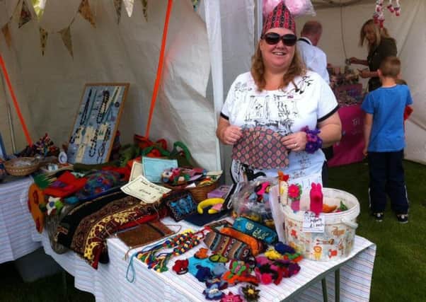 Jane Prendy selling topis and other items in aid of Hats off for Nepal at Whitehead Summer Festival. INLT-32-700-con
