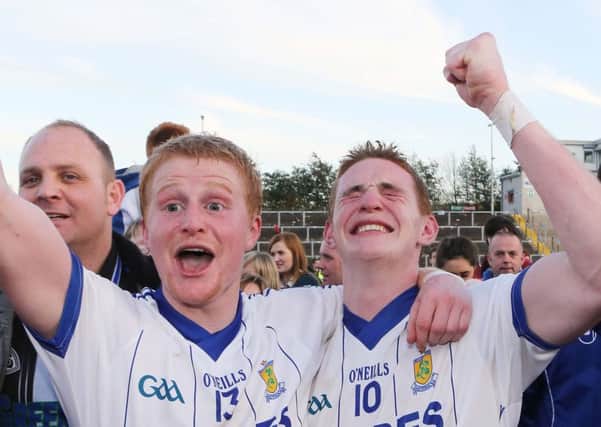 Ballinderry's Colin and Aaron Devlin celebrate