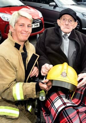 Former firefighter Thomas Hamilton, who recently turned 100, paid a visit to Portadown Fire Station last week, 45 years after he retired. He is pictured here with Firefighter Linda McKane.INPT32-211.