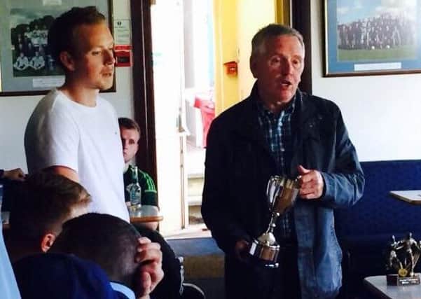 Ronnie Hooke (Snr) presents Frienship Cup to Dee Elliot (Derriaghy CC FC).
