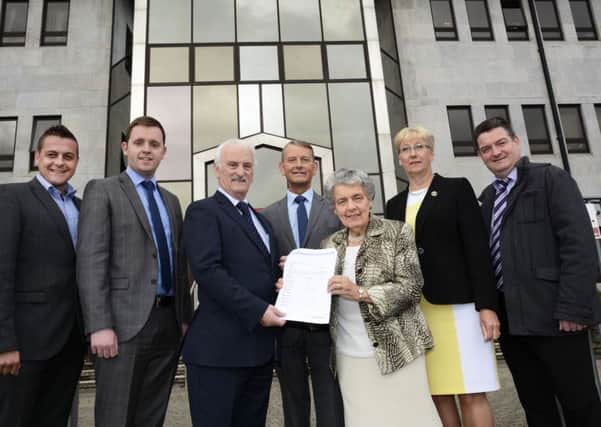 Unionist councillors, from left, Graham Warke, Gary Middleton MLA, Drew Thompson, Maurice Devenney, Mary Hamilton, Hilary McClintock and David Ramsey pictured with the petition against the name change. INLS3115-151KM