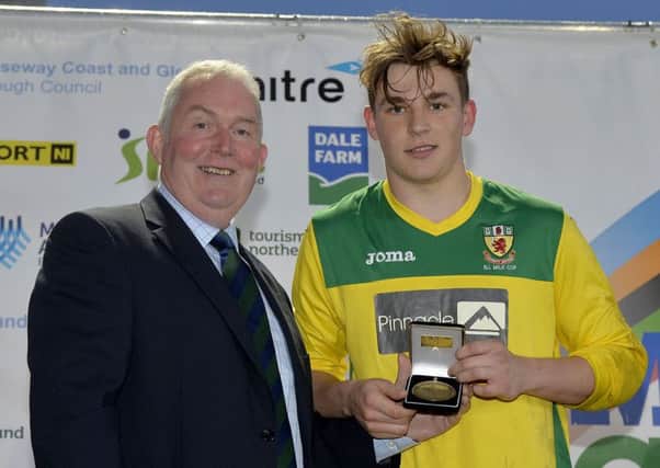Larne teenager Jack Ferguson was named Man of the Match at Friday's Milk Cup Premier Section final. He is pictured receiving his award from John Dunlop, chairman of Dale Farm. INLT 32-903-CON Photo: Presseye