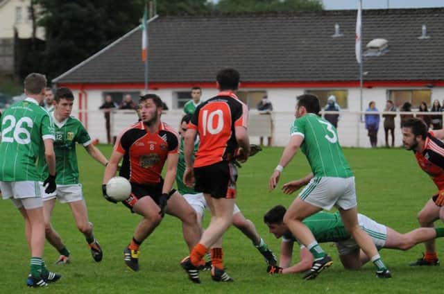 A St Joseph's Glenavy player tries to find a way through against St Mary's Aghagallon.