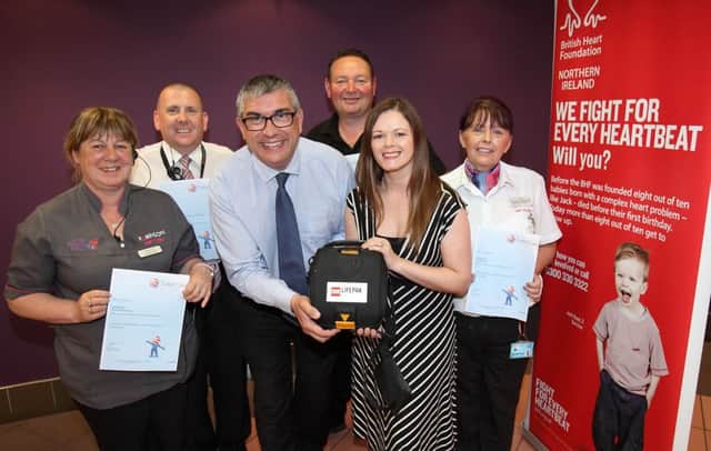 Gary Wilson, British Heart Foundation NI, and Karen Marshall, centre manager at Bow St Mall, pictured with staff members who have received training on using the mall's new defibrillator.   US1529-528cd  Picture: Cliff Donaldson