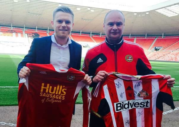 Sunderland AFCs Foundation of Light Brett McGoldrick and David McComb of Carniny Youth FC after securing the clubs partnership