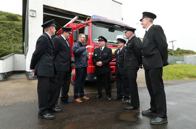 Minister Hamilton is pictured with Noel Darley, Paul Coyle, Noel McCurdy, Kevin Blaney, Clyde Grobler and Brian Teggart from the Northern Ireland Fire and Rescue Service at the Rathlin fire station.

Picture by Kelvin Boyes / Press Eye