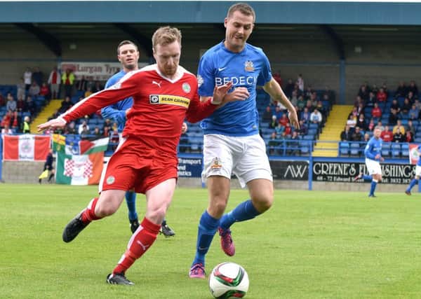 Glenavon's Ciaran Caldwell 
and Cliftonville's Chris Curran battle for the ball.