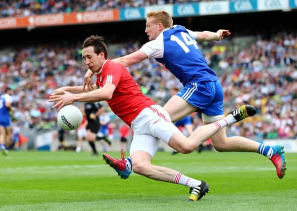 Monaghan's Kieran Hughes tackles Colm Cavanagh of Tyrone  ©INPHO/Cathal Noonan