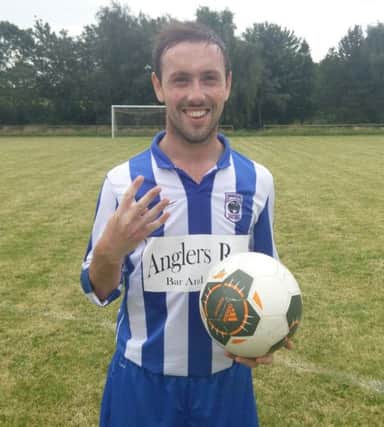Gregg Harrison shows off the match ball after hitting four goals on Saturday.