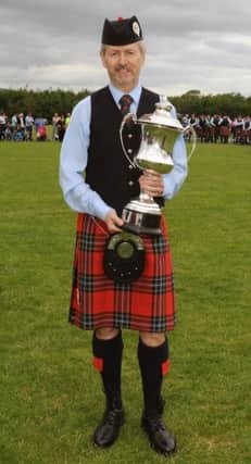 Pipe Major Richard Parkes MBE (Field Marshal Montgomery Pipe Band) pictured after receiving the Grade 1 All-Ireland first place trophy at the 70th All-Ireland Pipe Band and Drum Major Championships in Omagh on Saturday 4th July.