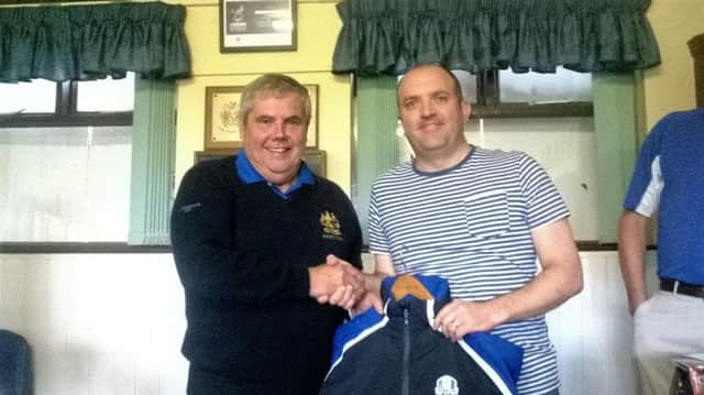 Aidan Daly accepts his prize from Club President Ritchie Gorman.