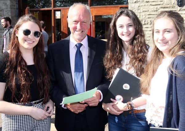 Pupils receiving their results at Ballyclare High School. Hannah Magee (4A's), Mr John Whincup (Head of Sixth Year), Anna Lawther (A*, A and B) and Megan Adams (B and 2C's). INNT-34-800. Picture by Freddie Parkinson