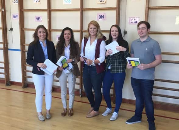 Pupils getting their results at Ballyclare Secondary School. INNT-34-801con