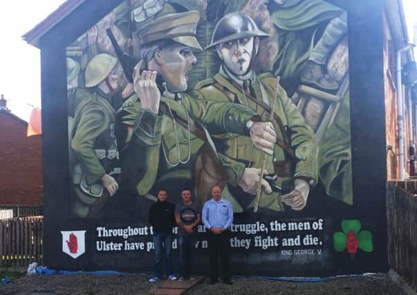 Pictured (l-r) at the unveiling of the new artwork are Mark Downes (Ballyduff Redevelopment Group), Phil Hamilton (East Antrim ACT) and John Read (Housing Executive Good Relations Officer). INNT 34-511CON
