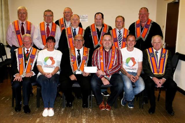 Eric Gilmore along with Lindsey Rodgers and Andrew Gilmore, of Leukaemia and Lymphoma UK are pictured receiving a cheque from Worshipful District Master David McConaghie and members of Ballymena District, proceeds from the annual mini twelfth collection. INBT34-234AC