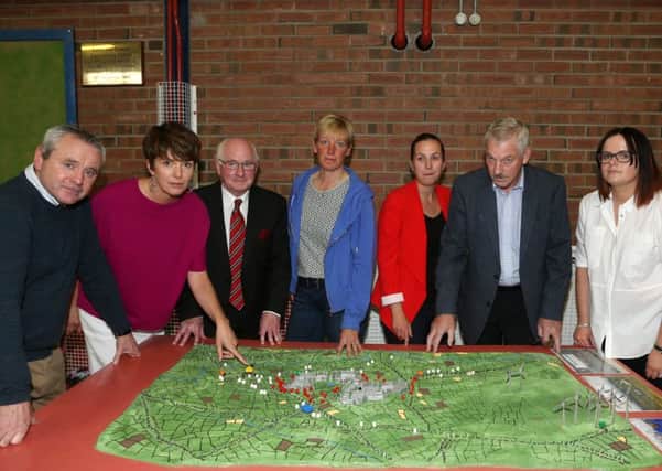 Members of Kells Vocal with a model of the area and how the proposed Solar Farm would look at a recent public meeting in Kells & Connor Community Centre. Included are Mervyn McMullan, Jane Burnside (vice-chairperson), Tom McGarry Arthurs, Nikki Nesbett, Pamela Dennison (secretary), Ed Crawford (chairman) and Eileen Russell. INBT 32-101JC