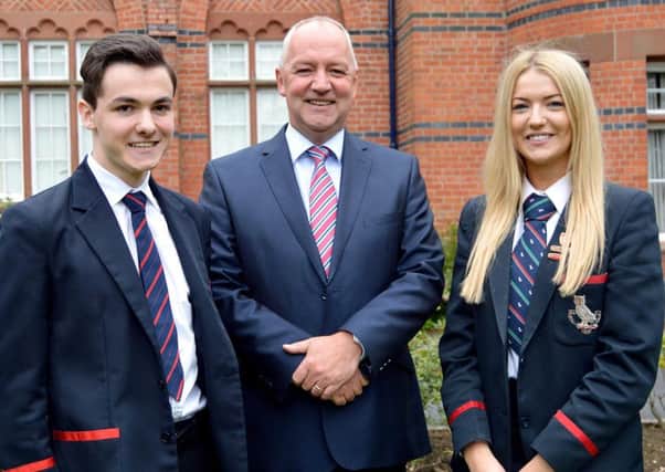 Lurgan College principal, Mr Trevor Robinson pictured with the two top performing 'A' level students following the announcement of results last Thursday. Matthew Canning achieved three A* grades and one A grade and head girl, Megan Collins achieved one A* and three A grades. INLM32-202.