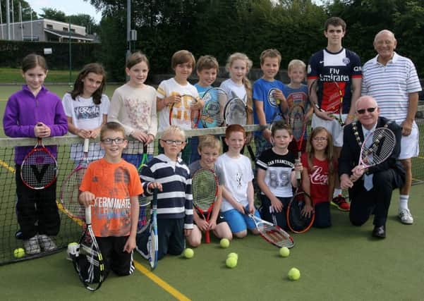 Mayor of Mid and East Antrim, Cllr. Billy Ashe, is pictured with participants in the 20th Junior Tennis Festival at the Peoples Park, by Ballymena Lawn Tennis Club. Included are coaches Fergus Barkley and Ian Wilson. INBT33-221AC