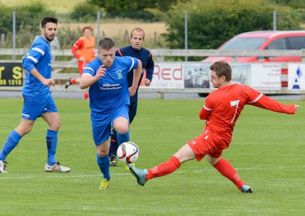 Dollingstown Andy King moves past Coagh's Jamie Tomelty