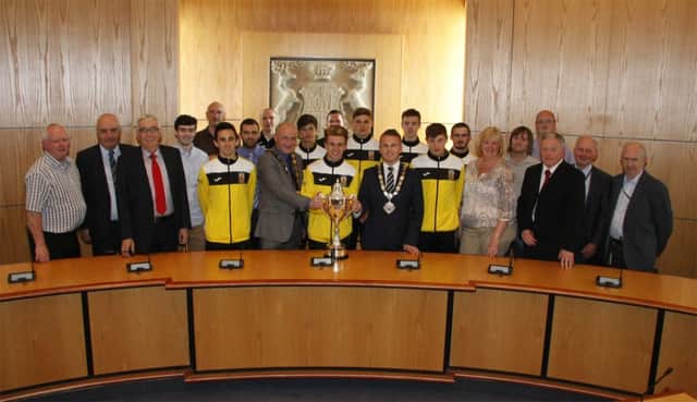 The Mayor, Cllr Thomas Hogg and Deputy Mayor, Cllr John Blair are pictured with Trevor Clarke, MLA and Council Members in the Council Chamber at Antrim Civic Centre along with members of the Co Antrim Milk Cup Team.