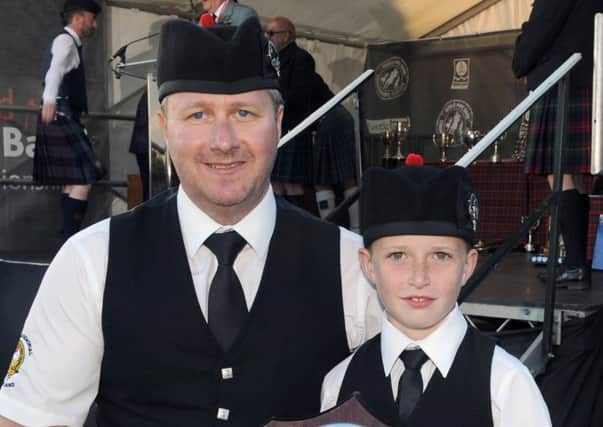 Pipe Major Norman McDonald and Jack Hamill (McDonald Memorial Pipe Band) after receiving the trophy