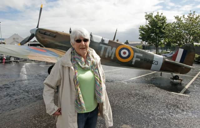 FLIGHT. Pictured beside a spitfire in Ballymoney on Saturday is Linda Beattie, whose Father, Flight Lt Matthew Cameron fought in the war.INBM34-15 055SC.