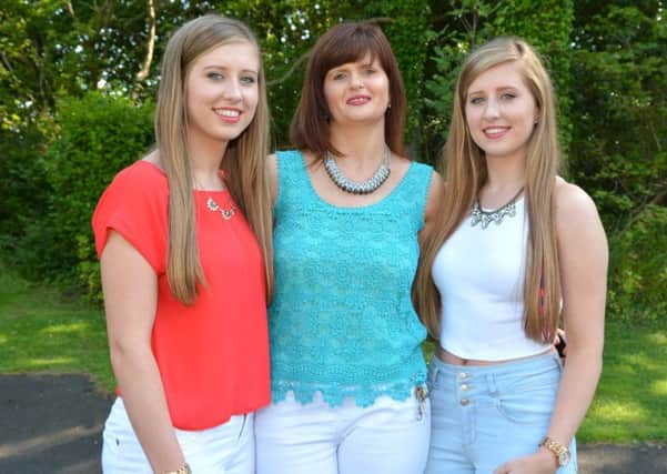 Doubly proud mum Joanne Mulvenna with her daughters Andrea and Michaela, who achieved straight A's or better in their A Level results.  INLT 33-718-BM