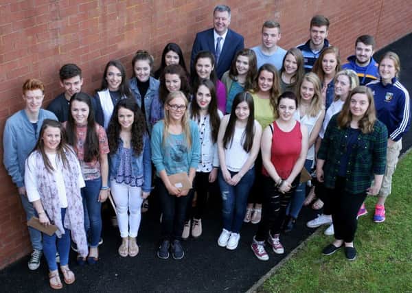 Students from St. Louis Grammar School who achieved three A's or more in their A Level exams, pictured with principal Sean Rafferty. INBT34-205AC