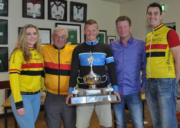 Damien Shaw receives the John Beggs Memorial Trophy from the Beggs family and Race Director Aaron Wallace.