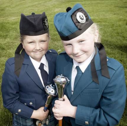 Little Emily Crooks and Kara Gilmour smile for the camera at the pipe band championships.INBM24-12 224JC