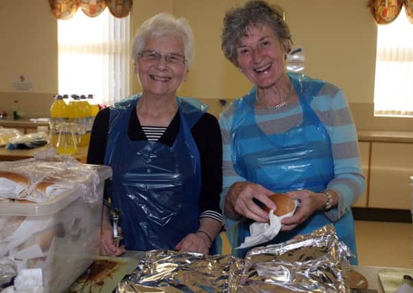 Mary Sutters and Sally McKeown serving the burgers and hotdogs at the Harryville Presbyterian Church fun night. INBT34-233AC
