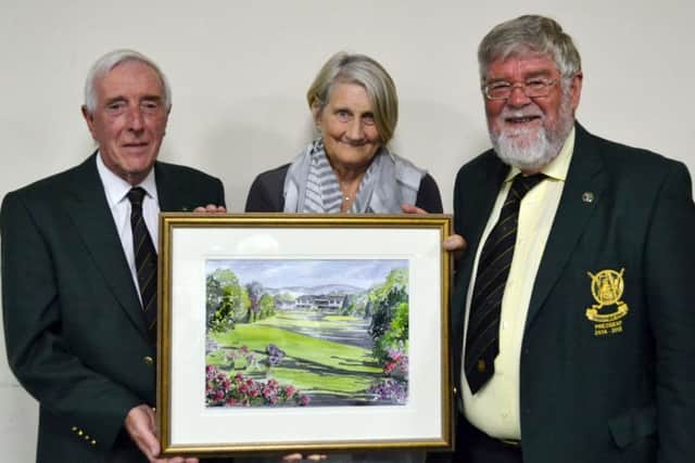Ivor McCandless receives his prize from the President Andrew Crawford and his wife Linda.