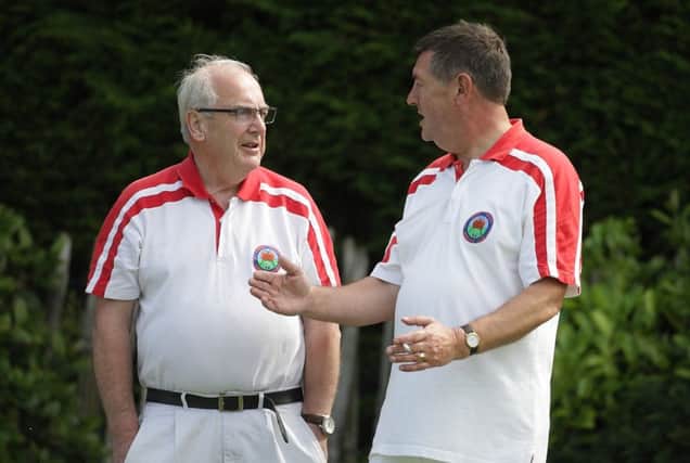 Discussing tactics during the match between Lagan Valley and Glengormley, at Lagan Valley Bowling Club. US1533-563cd  Picture: Cliff Donaldson