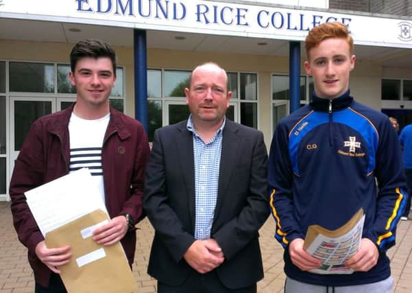 Edmund Rice College GCSE students Rory McFadden and Cillin Gilmour with principal Peter Friel. INNT 35-500CON