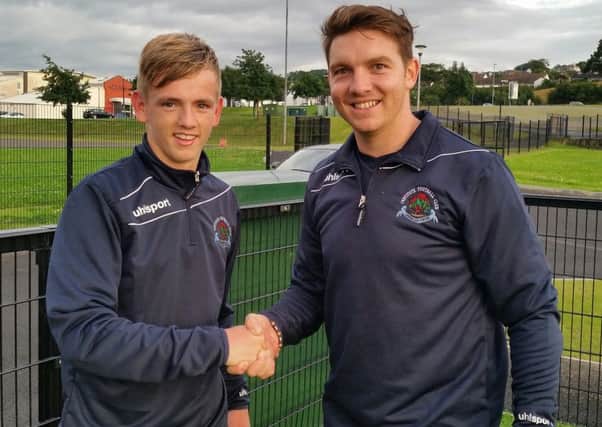 Institute manager Kevin Deery welcomes new signing Ciaron Harkin to training this evening.