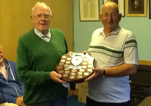 Ian Montgomery, club secretary, presents the Jean Gilliland shield to Willie Taylor following the mens victory over the ladies in their Lisnagelvin encounter.