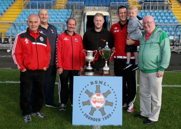 Jackston Ewart and Colin Rainey, from Randalstown FC (Division 3 winners) and Garry Bonnes and his son Parker, from Harryville Homers (Division 1 winners) at the launch of the Ballymena Saturday Morning League with league sponsor representative Donald Crawford of Firmus Energy. Included are league officials Davy King (Chairman) and Brian Montgomery (Secretary). INBT34-222AC