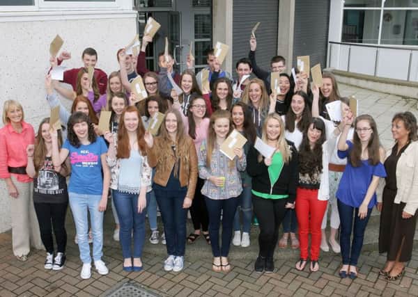 Students from Cambridge House Grammar School celebrate their excellent GCSE results. Included is Mrs. E. Lutton (Principal) and Mrs. McClurg. INBT35-217AC