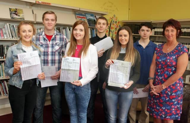 WELL DONE. Principal Elish Gillan along with the school's top achievers, who are, Maria McNamee (11 GCSEs), Conor Thompson (11), Sorcha Connor (11), Narcin Buczma, (10),  Eimer Delargy (12) and Mateusz Bubacz (11). Not included are Dmacha McMullan (10) and Dina Ekupe (10).INBM35-15 019SC.