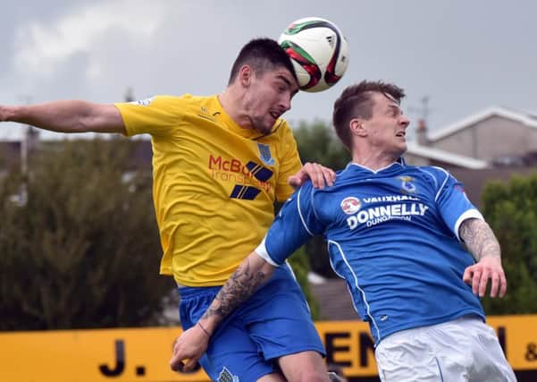 Ballymena United defender Michael Ruddy wins a header against Dungannon's Paul McElroy during today's Danske Bank Premiership game at Stangmore Park. Picture: Press Eye.
