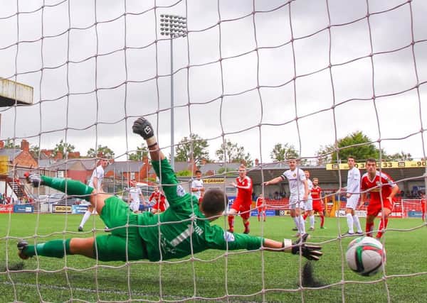 Cliftonvilles' George McMullan scores past Carrick Rangers Brian Neeson