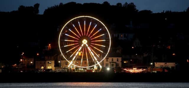 As thousands of people converge on Ballycastle for the Oul Lammas fair weekend the town has come alive to the lights of the Giant Wheel and amusements at the Harbour. PICTURE KEVIN MCAULEY/MCAULEY MULTIMEDIA