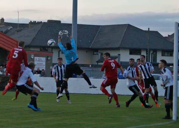 Wakehurst keeper Marc Maybin attempts to collect a high ball during his side's midweek JBE League Cup tie at Ballyclare Comrades.